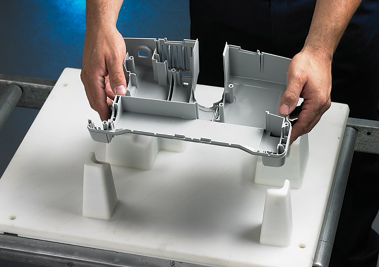 Oreck uses additive manufacturing to produce custom assembly
pallets. During assembly, a vacuum top cover is placed into the
pallet upside down.