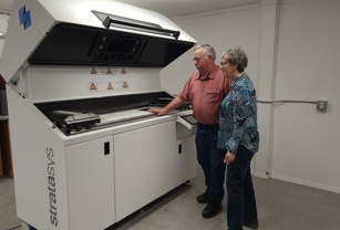 3D composites standing next to Stratasys printer