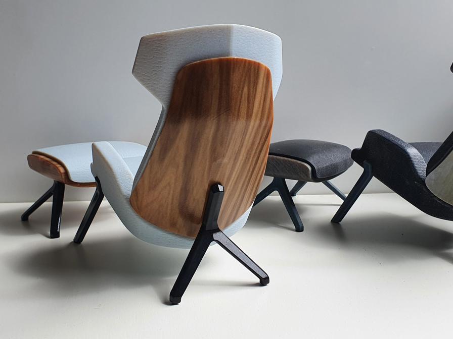 Scale models of a chair, accurately replicating wood and leather textures, designed by Thinkable Studio