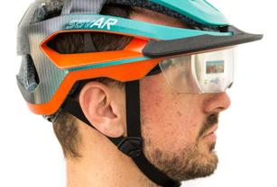 Model of a bicycle helmet, including complex AR technology within the see-through visor, as well as indicator lights and striking design textures – 3D printed by Thinkable Studio on the J55