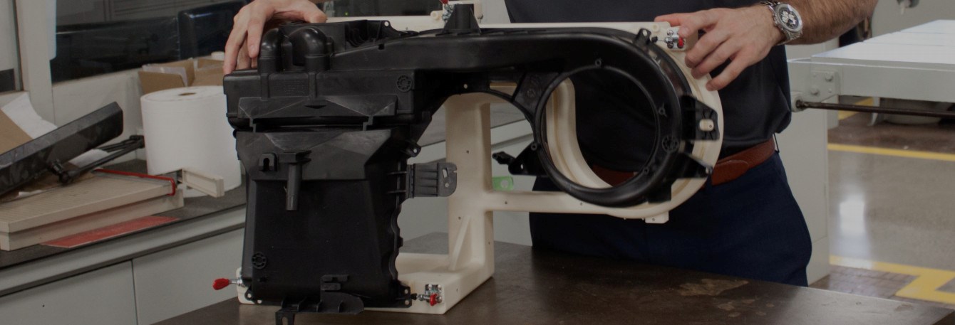 an engineer assembles a 3d printed automotive fixture for mahle