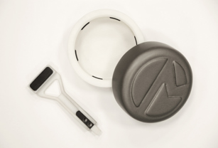 A grasping pincer (left) and packaging lid (right) –   3D printed with Stratasys PolyJet technology. Multimaterial 3D printing was used to create the white structural components and black rubber-like grips all in a single print.