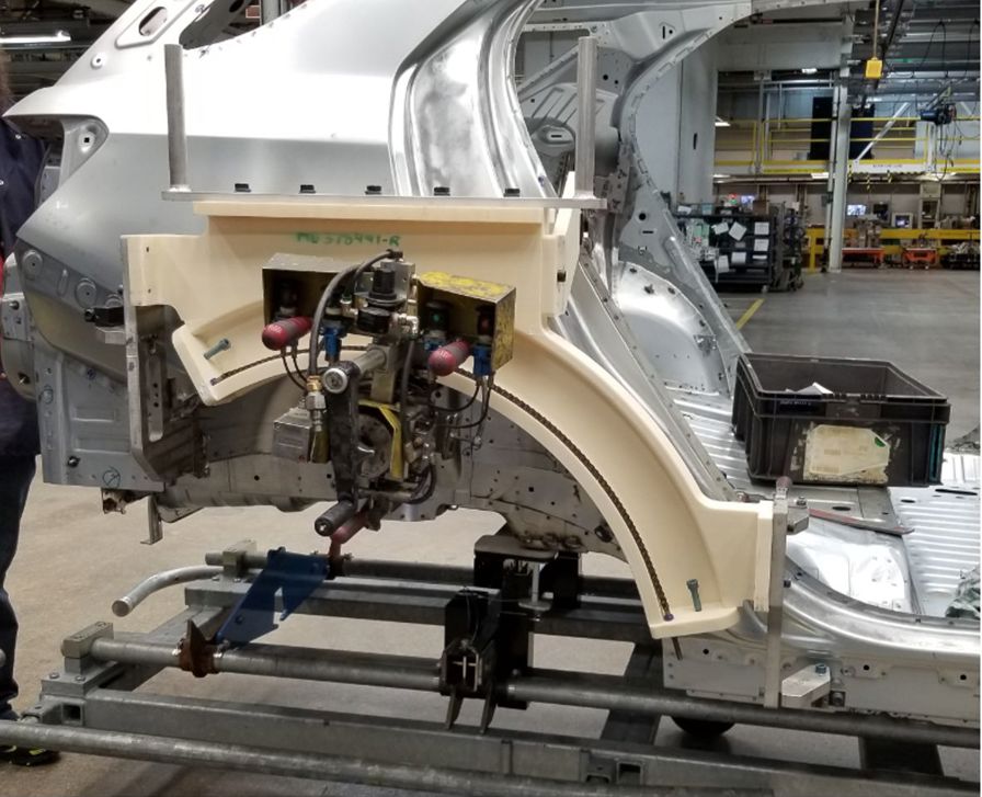 The wheel arch hemmer tool (ivory) made from ASA thermoplastic.