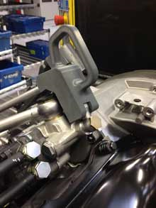 This Stratasys 3D printed hose holder (in gray) is used to maintain the position of an engine hose during engine assembly by the production line operator. These 3D printed tools are designed and produced 94% faster than before. 