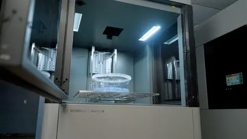 3d printer with door ajar showing printed part