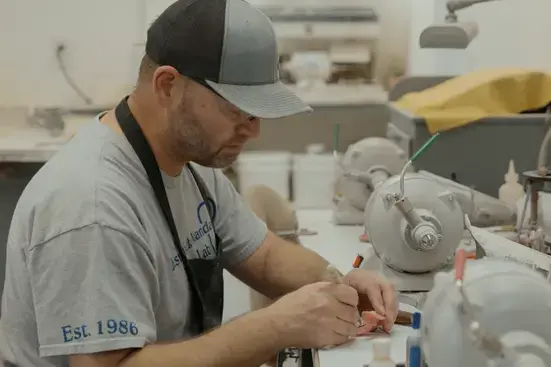 Dental lab tech assembling a removable partial denture