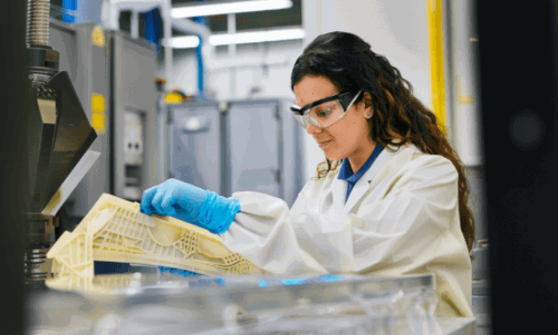 Woman inspecting 3d printed part Stratasys Direct